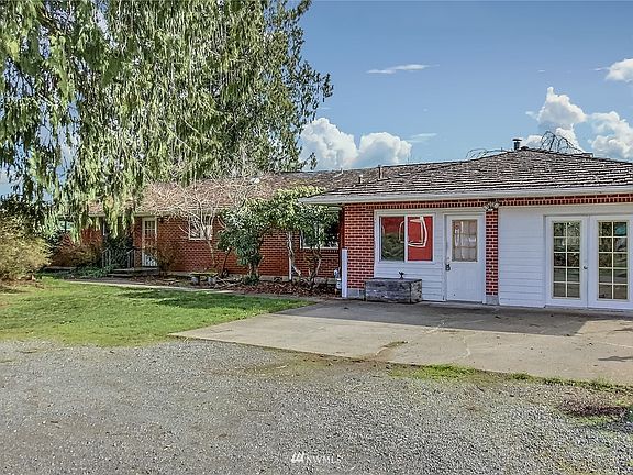 View of front of sprawling rambler, former garage converted in past to child care, options are endless! 