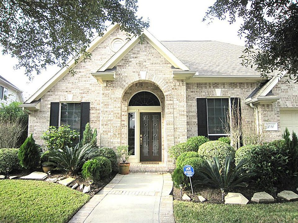 This inviting one story has a covered front porch and lush mature landscaping.