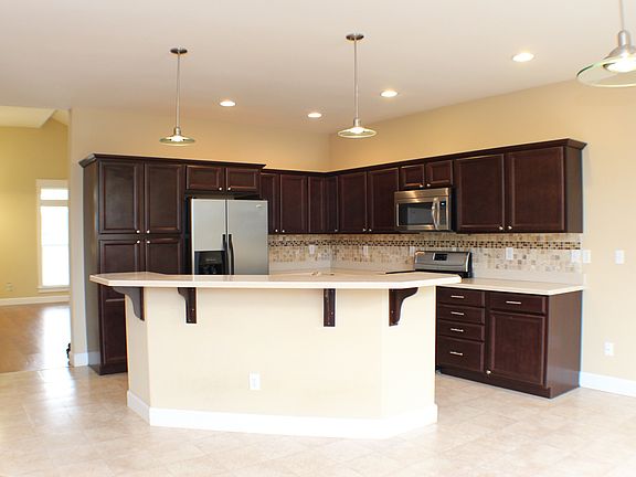 Dark cabinetry, tile backspl