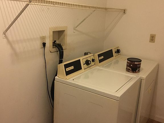 laundry room with extra storage, this washer and dryer included if needed