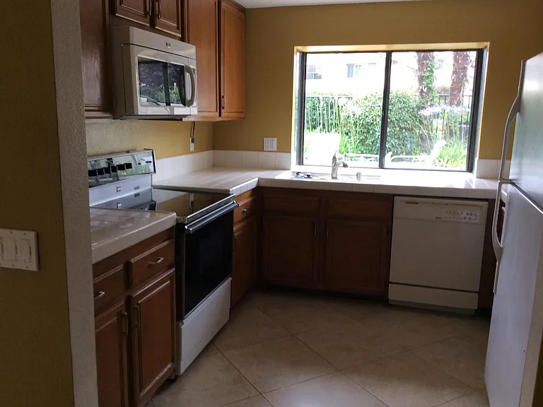 kitchen looking out to patio and situated on the western exposure green-belt