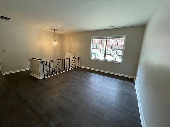 Living room and view of entryway split level entry. Brand new beautiful floors