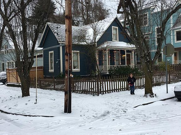 house in snow, fenced yard