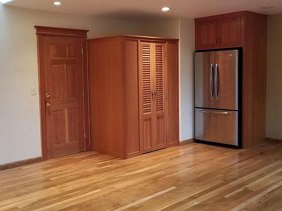 Dinning area, pantry and stainless steel fridge.