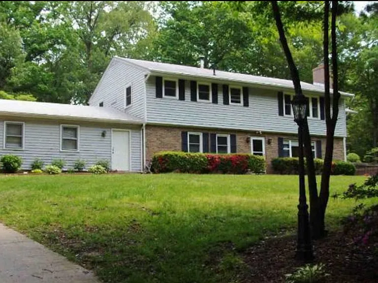 Apartment entrance is the white door near the garage