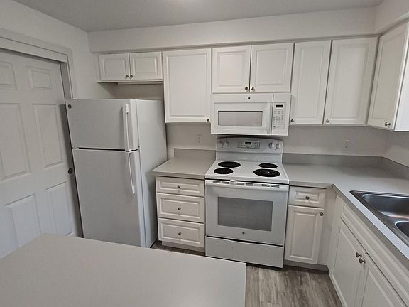Kitchen stove, microwave, garbage disposal and dishwasher.