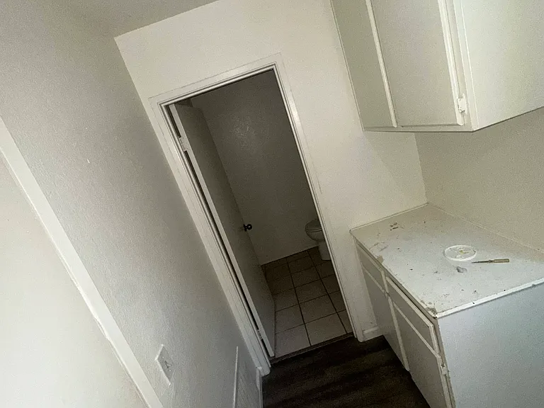 Downstairs hallway with storage, leads to bathroom and garage