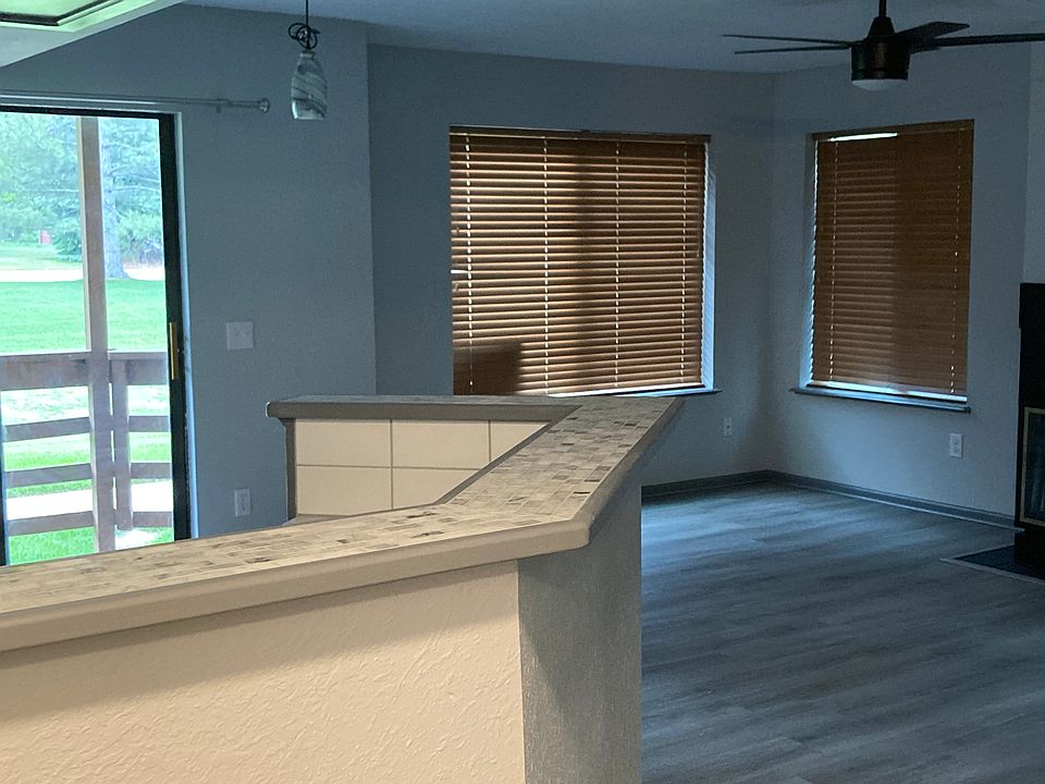 Walking into unit from front door. Wood blinds featured