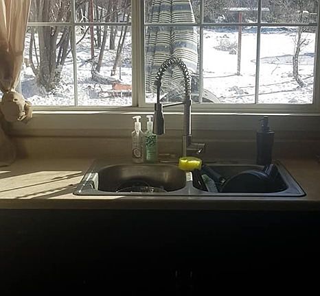Kitchen sink looks back yard