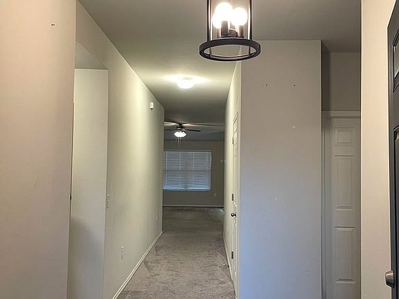 Hallway to the living straight ahead. There is two Bedroom and a common full bath to the right from here and one bedroom, laudry room and garage door to the left from here.