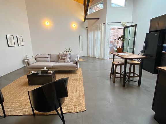 Living Area (l) Kitchen/Dining Area (r) Courtyard (background)