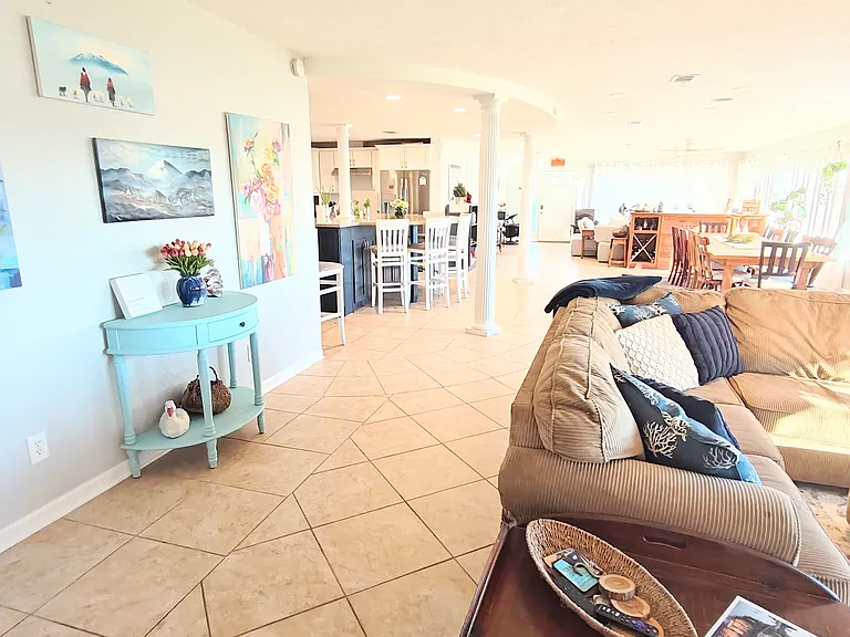 Looking from one end of the font room to the other (looking east, house faces south). Living area to the right, dining area and kitchen next, then second living/office area.