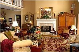 Two story Living room off the travertine tile floor entry boasting interior co