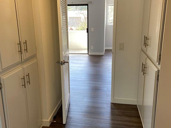 Hallway with cabinets/storage space.