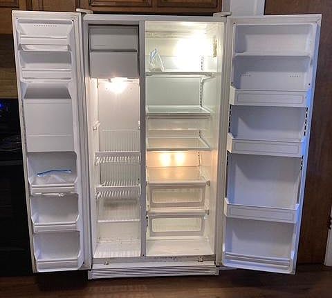 Large refrigerator w ice & water dispenser to hold food for a larger family.