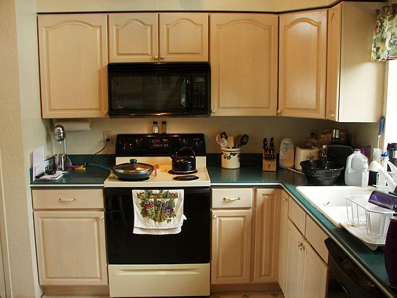 Kitchen has maple cabinets, corian countertops
