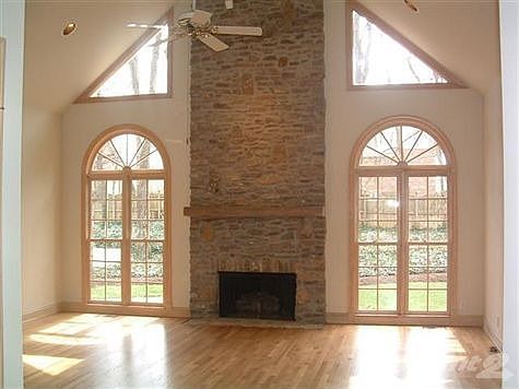 VIEW OF GREAT ROOM WITH FLOOR TO CEILING ROCK FIREPLACE & HEARTH WITH LIGHTED WETBAR.