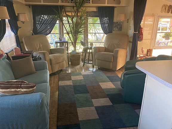 Living room which is open to kitchen and to the lanai