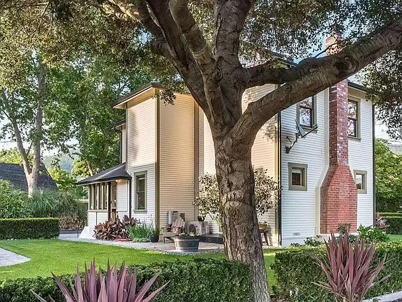 South facing view of the farmhouse & yard with big oak tree