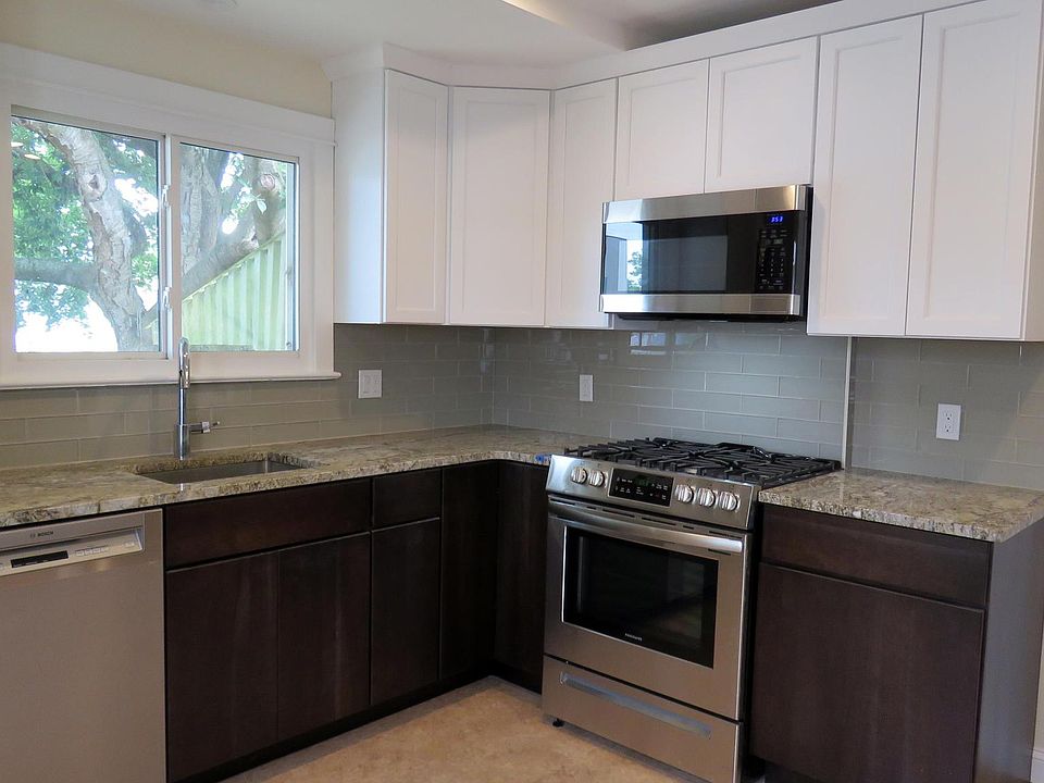 Remodeled kitchen with cherry cabinets and granite countertops.