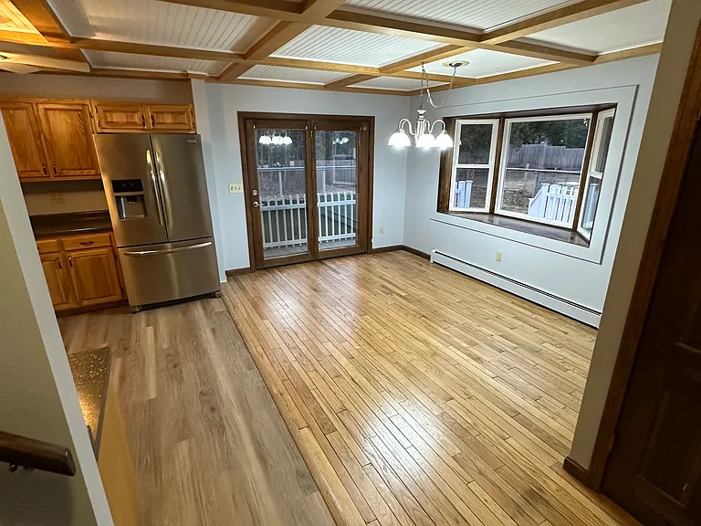 View of bay window in dining room, overlooking large back yard.
