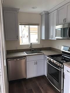Kitchen includes dishwasher, large sink, microwave over gas range and refrigerator. Lots of natural light.