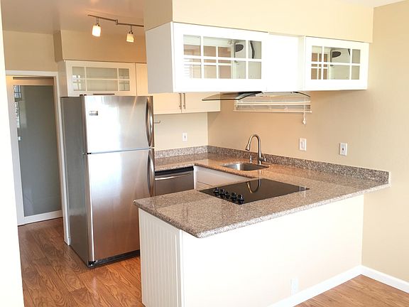 Renovated kitchen with granite counters and stainless appliances