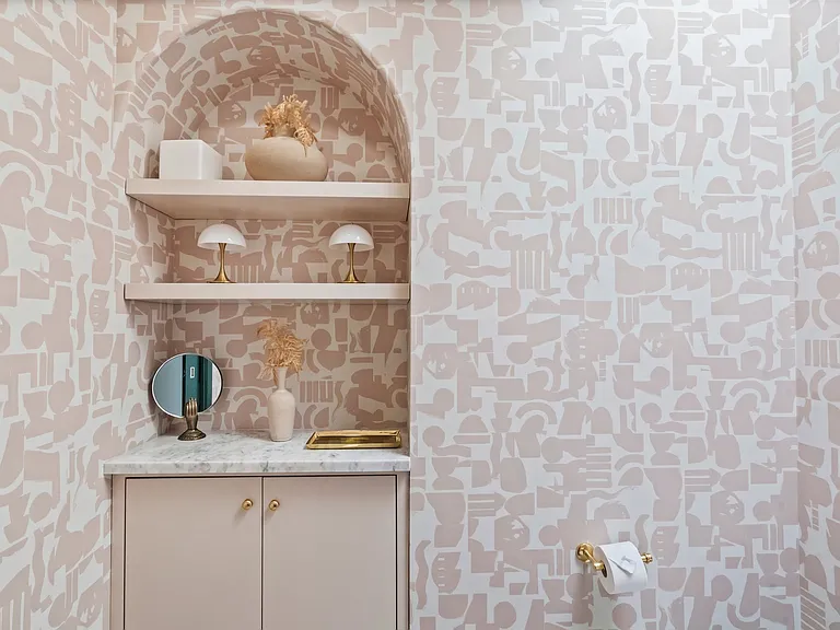 A powder room with personality_soft hues and sculptural accents.