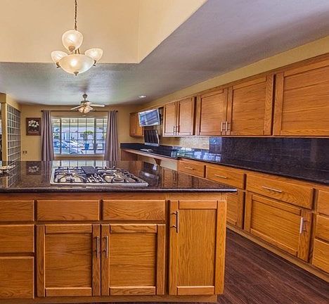 Beautiful cabinets and gleaming black granite counters make this kitchen wonderful!