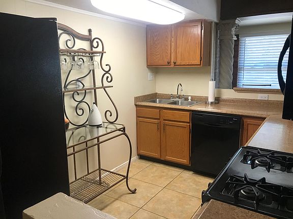 Kitchen Includes Refrigerator, Gas Stove, Microwave, and Dishwasher.