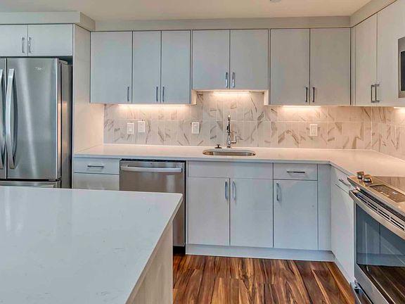 Premier homes feature modern kitchens with upgraded refrigerators, granite countertops and separate dining space
