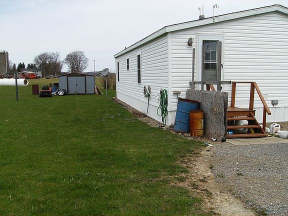 back of house with shed and