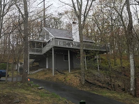 View from the main road showing the driveway going up to the home