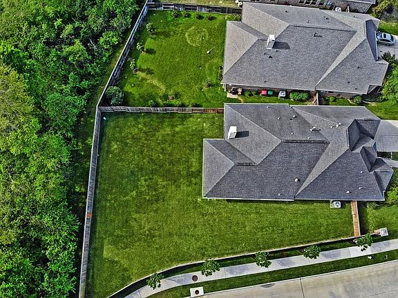 This corner lot is compete with a large backyard and large mature trees behind the backyard.
