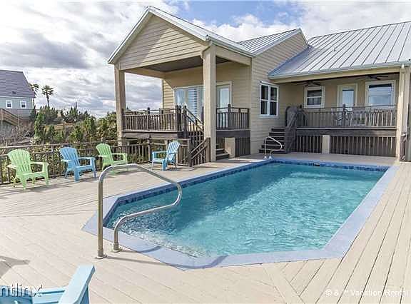 The front balcony overlooks our pool, with a view of the oce