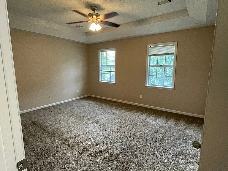 At the end of the hallway on the right is the master bedroom with tray ceiling, ensuite bathroom & large walk in closet