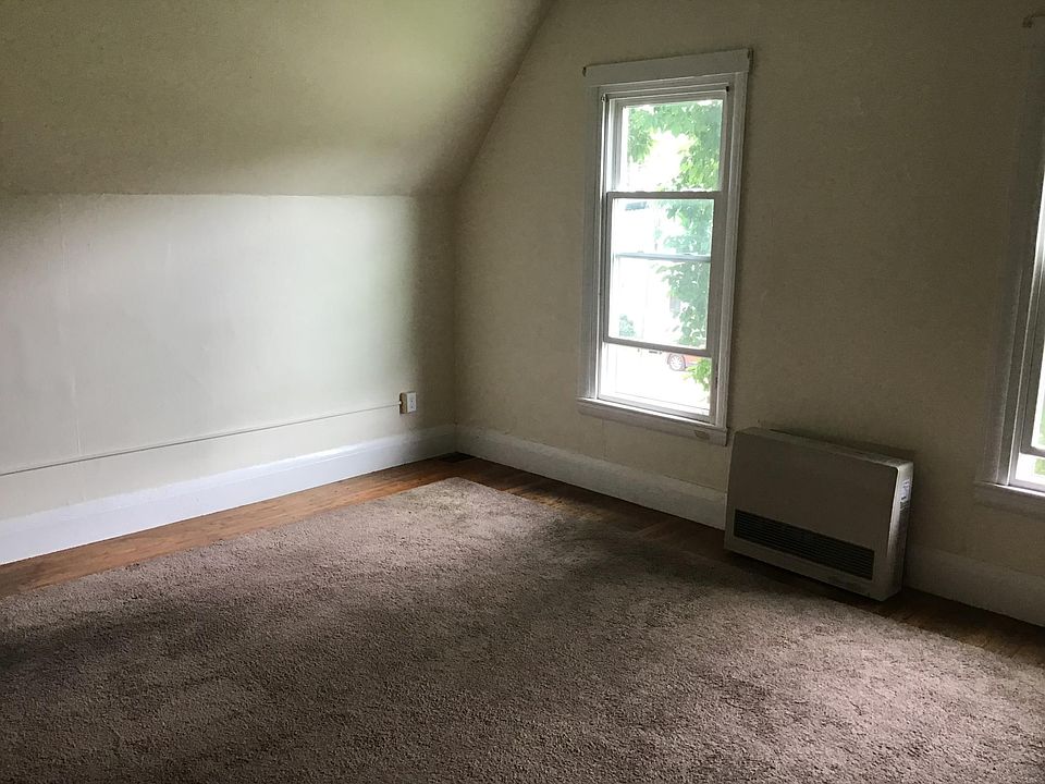 Living room with area carpet, hardwood flooring .
