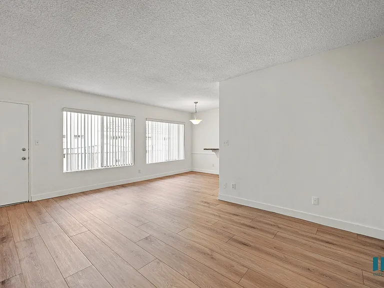 Spacious Living Room with Vinyl Flooring and Large-Size Windows