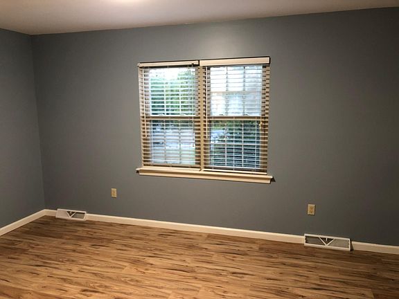 Master bedroom with new paint and laminate flooring.