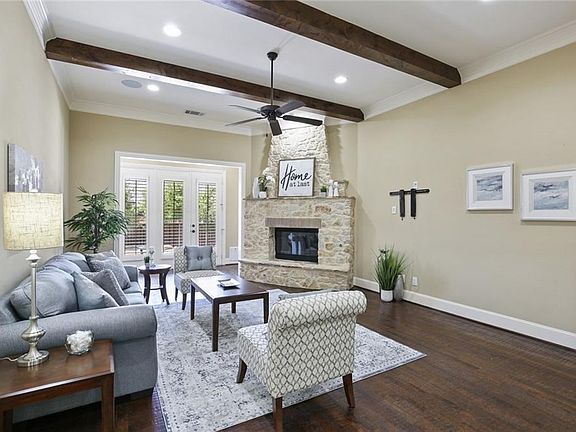 The wood floors continue through most of the downstairs, beams in the ceiling of the family room, as well as a beautiful stone fireplace and doors that lead to the backyard and pool.