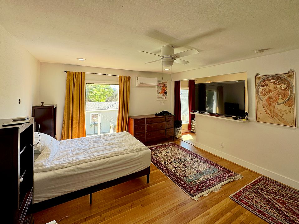 The sleeping space mirrors the living space. The storage area behind the half wall functions like a walk in closet.
