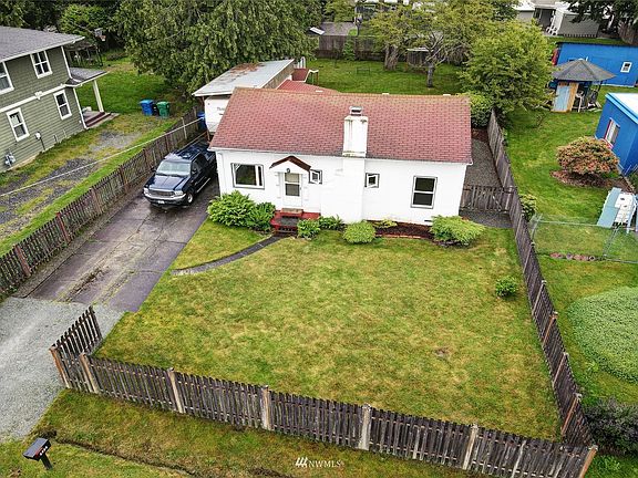 This gorgeous Spanish style cottage in Arbor Heights has a stunning 8,520 square foot lot!
