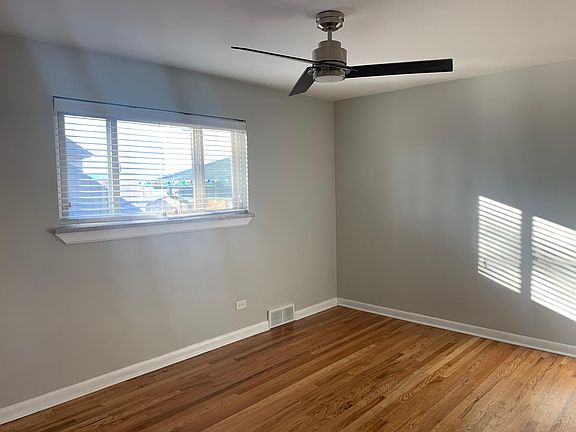 Master bedroom with view into garden and lots of natural light as well as LED fan and light.