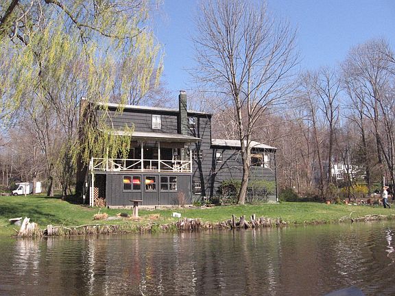 Porch overlooks pastoral pond