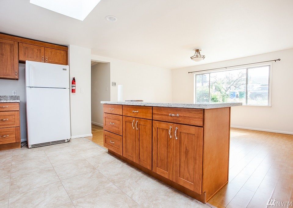 Large kitchen with dishwasher, stove, oven, microwave. Large island with granite counters. Large eating area