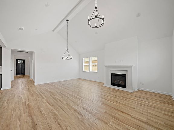 Great room dining area with vaulted ceiling