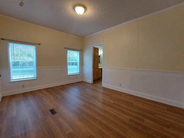 Back Master Suite also has 2 bright windows with blinds and hung curtain rods.