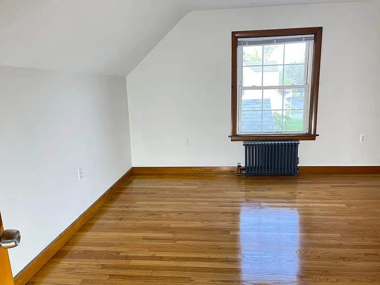 Entrance to second 2nd-floor bedroom with hardwood flooring, built-in dresser and bookcase