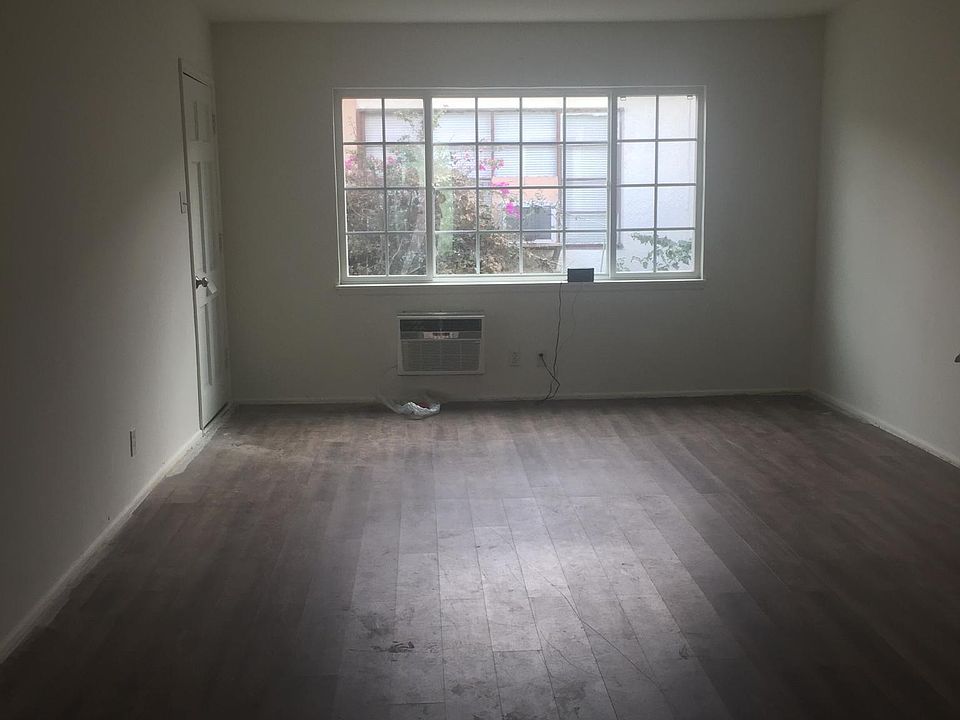 living room with AC/heater, front door