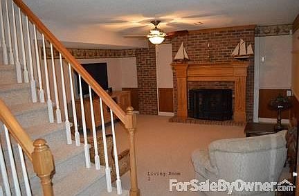 MIL Apt Living Room
						:
						Note stairs to first floor and gas log in fp
